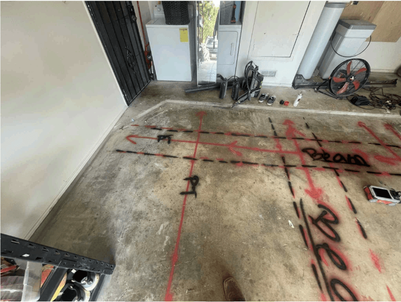 Concrete slab marked with red and black layout lines after a GPR scan