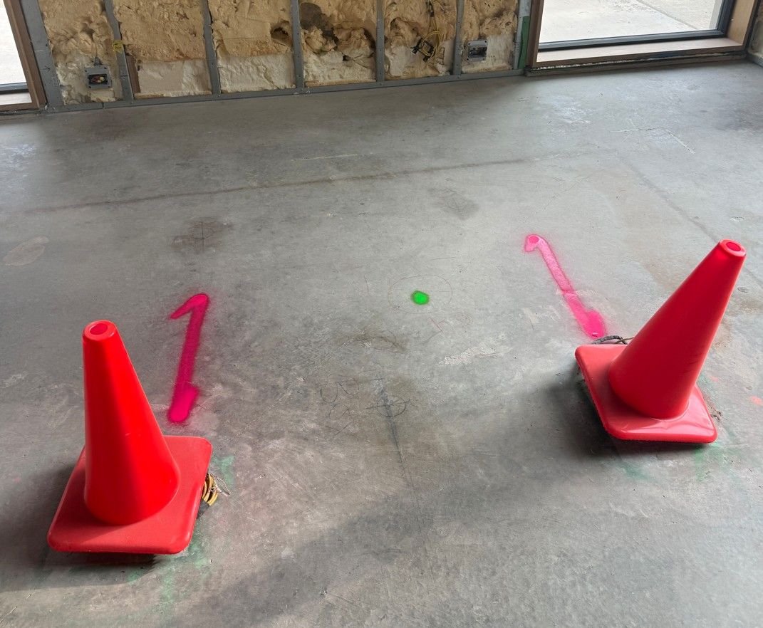 Cones and paint marks flagging post-tension cables before coring